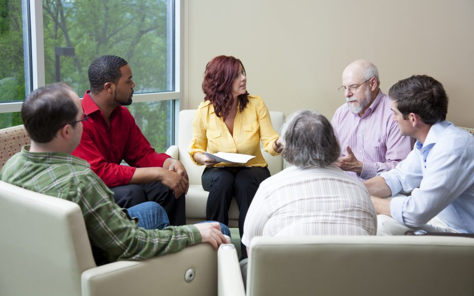 Men and women discussing in a support group