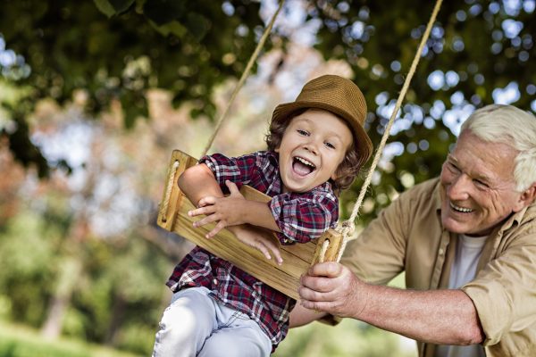 grandfather and his grandson on swing