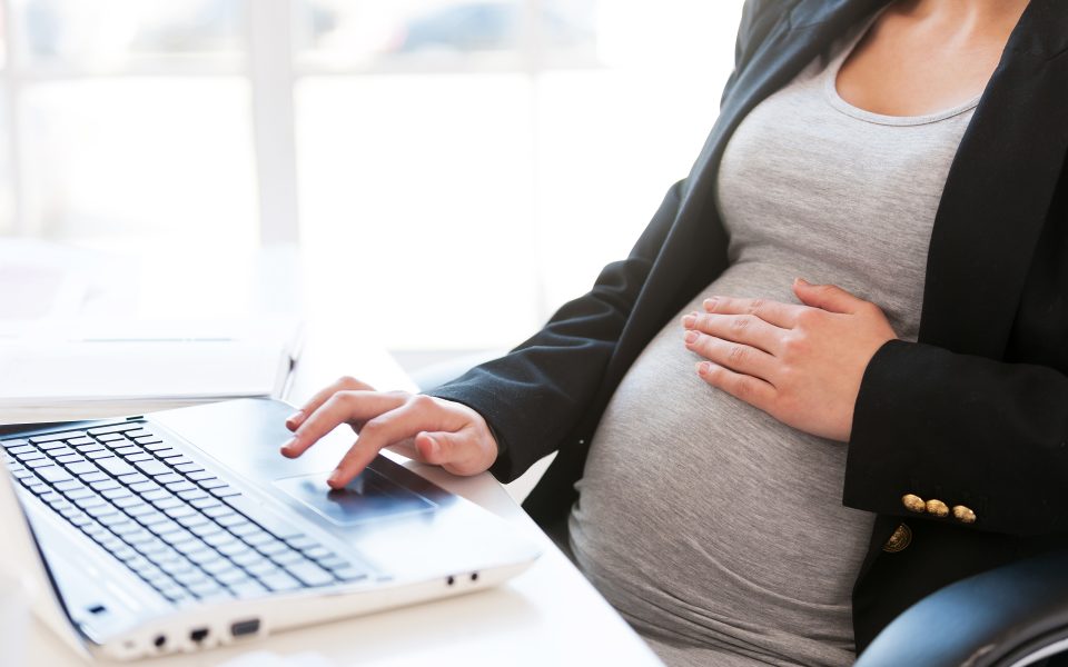 Pregnant woman using a laptop computer