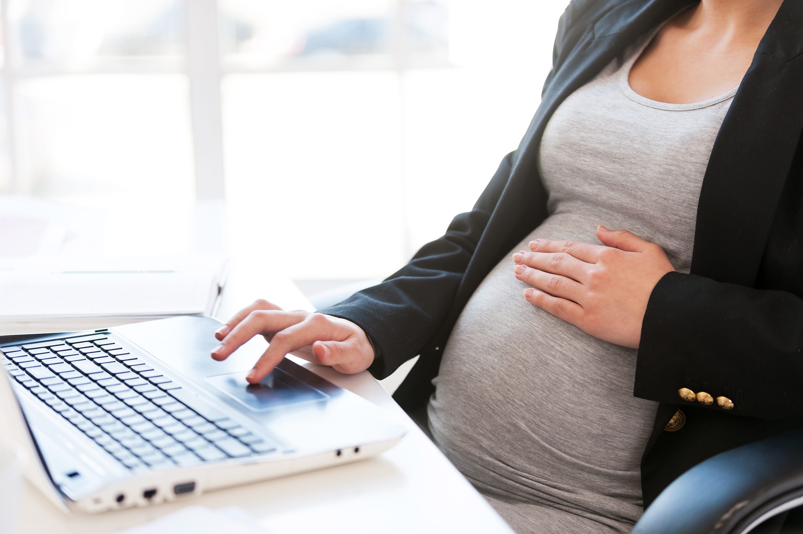 Pregnant woman using a laptop computer Fairfield Medical Center