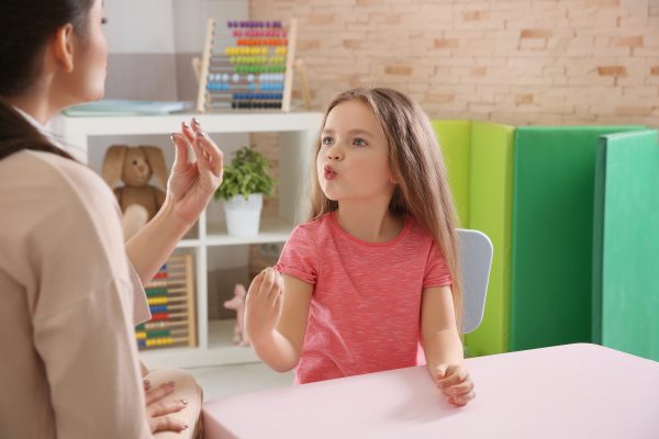 Little girl working with speech therapist