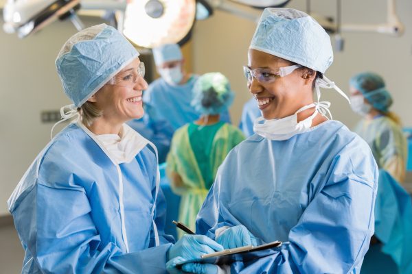 Female surgeons consulting about patient in operating room