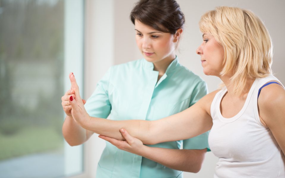 Therapist examining female patient's wrist