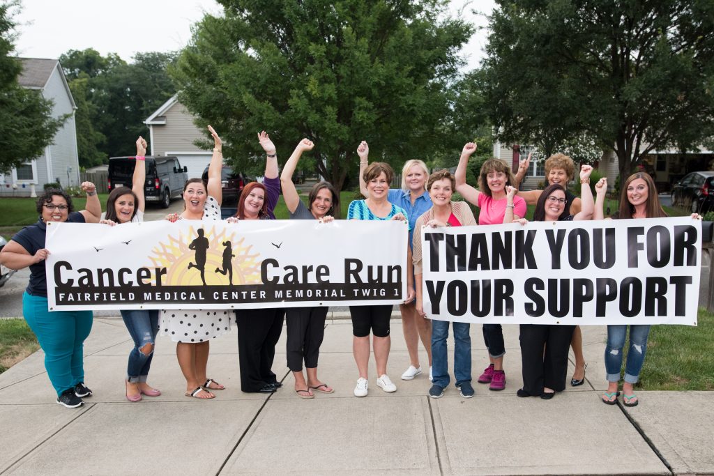 Fundraising group holding up sign to thank participants of a run