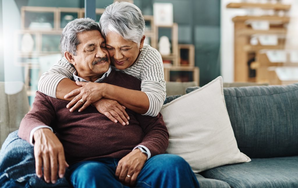 elderly woman hugging her husband