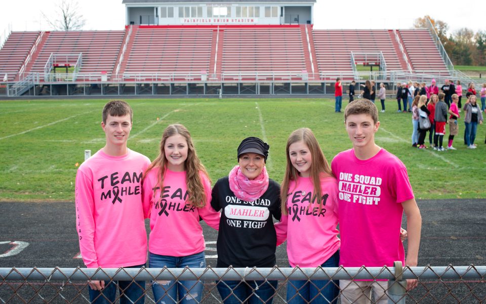 Breast cancer survivor with her family promoting breast cancer awareness at fundraiser