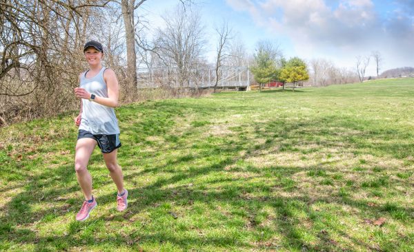 Young female cancer survivor running in a park