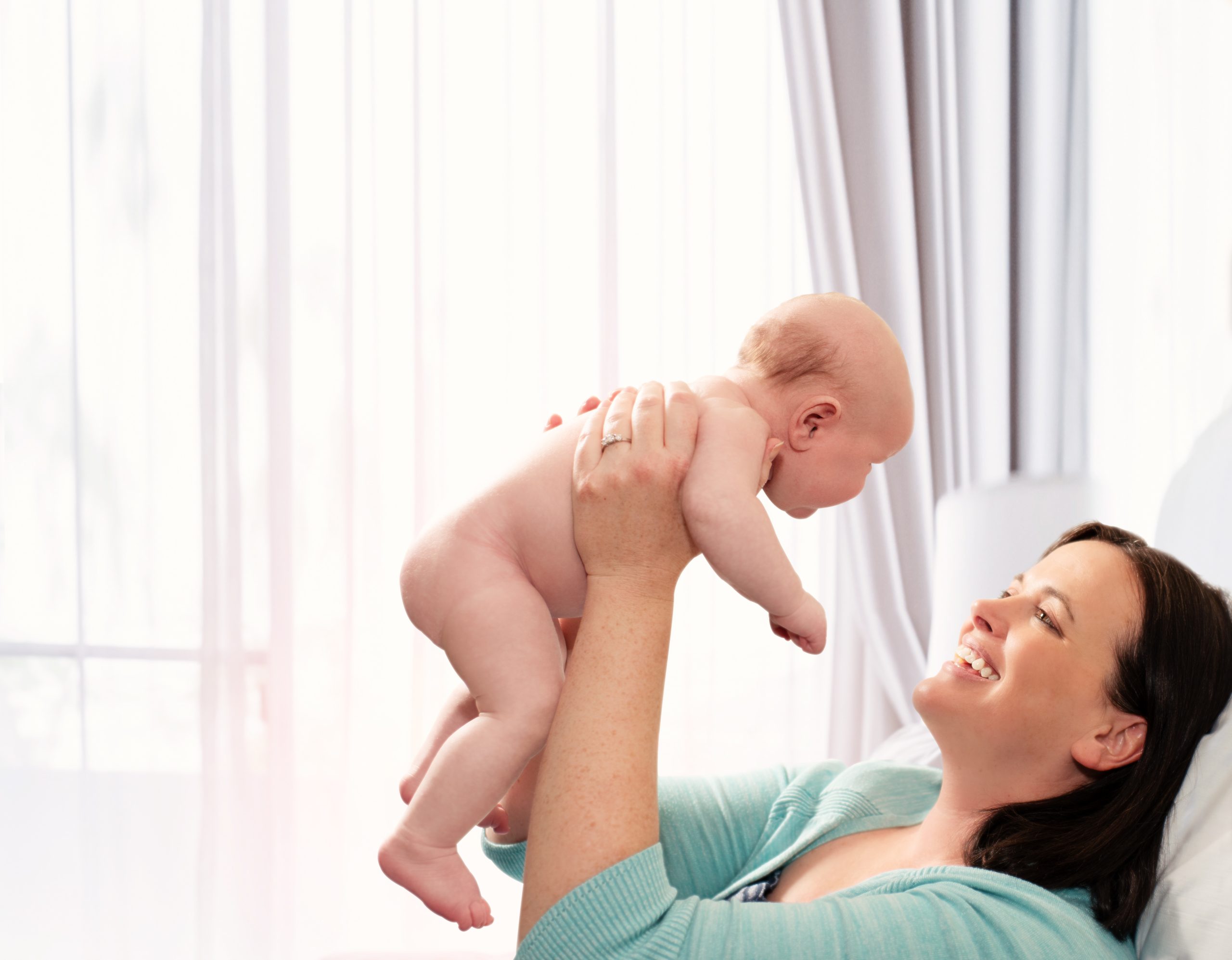 Mom and holding baby in the air Maternity Mom and holding baby in the air Maternity