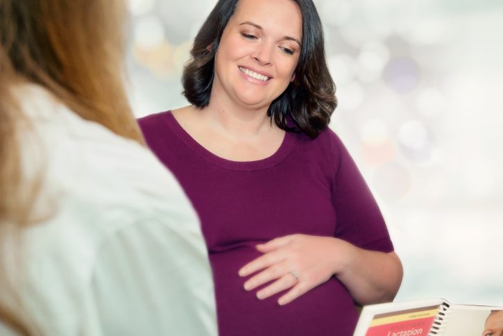 Pregnant woman discussing lactation management with physician