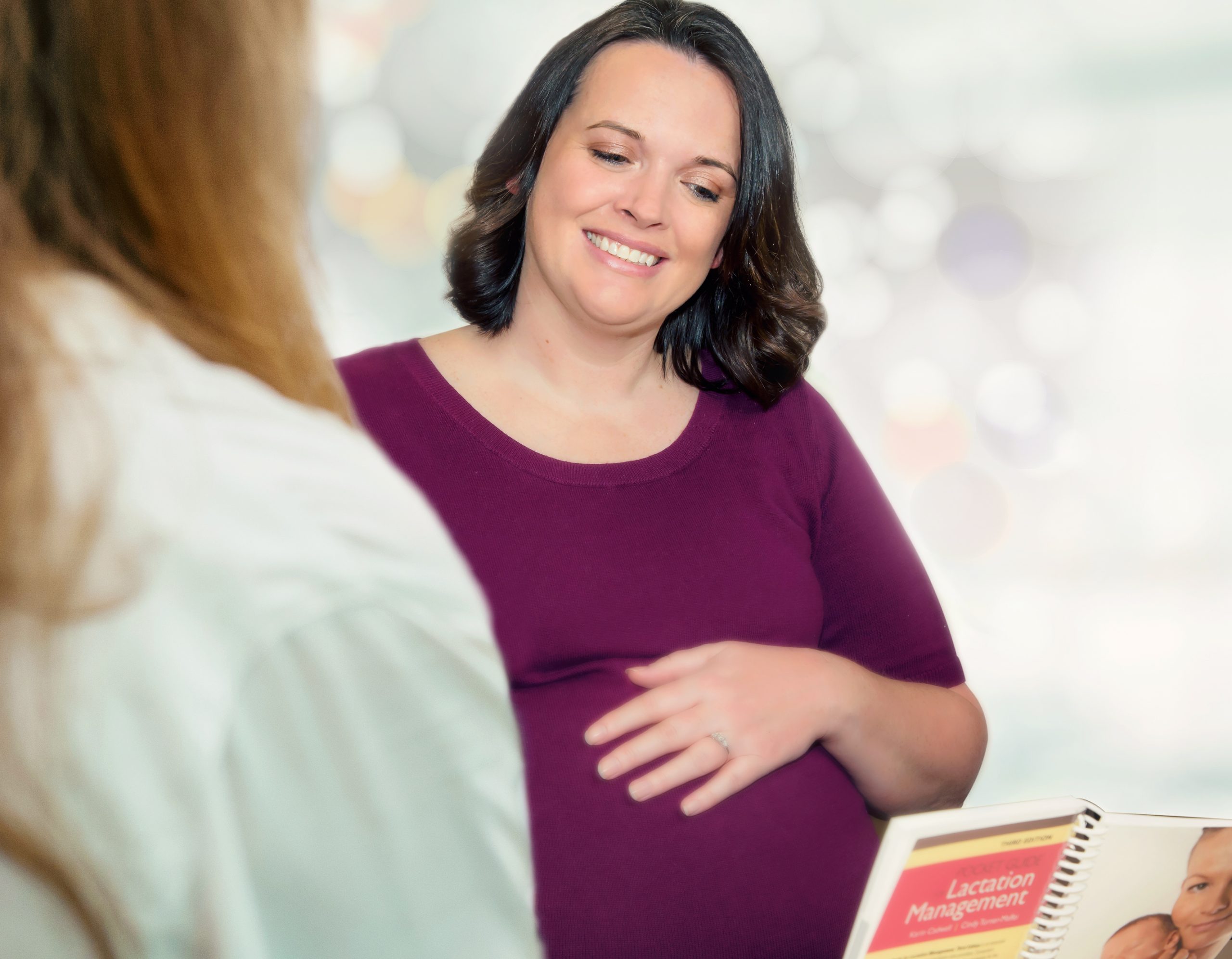 Pregnant woman discussing lactation management with physician