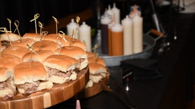 Pulled pork sliders and various sauces associated with barbecue at Basketball and Brew