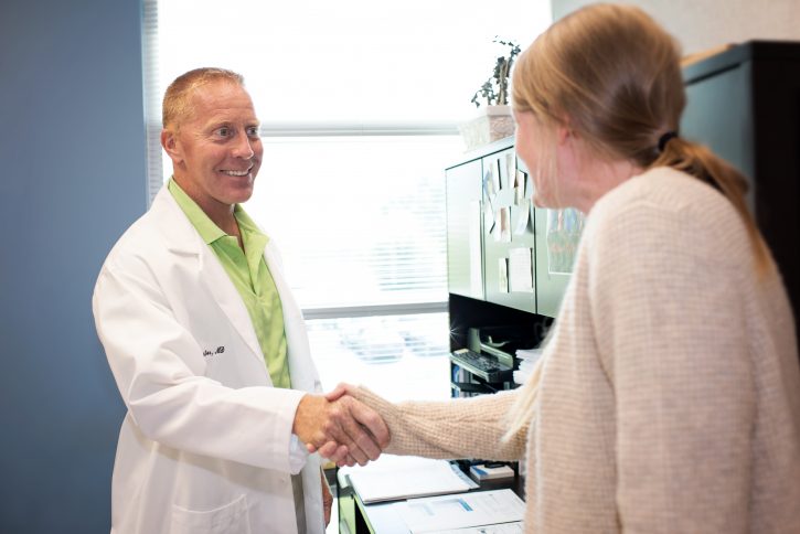 Dr. Custer shakes hand with patient