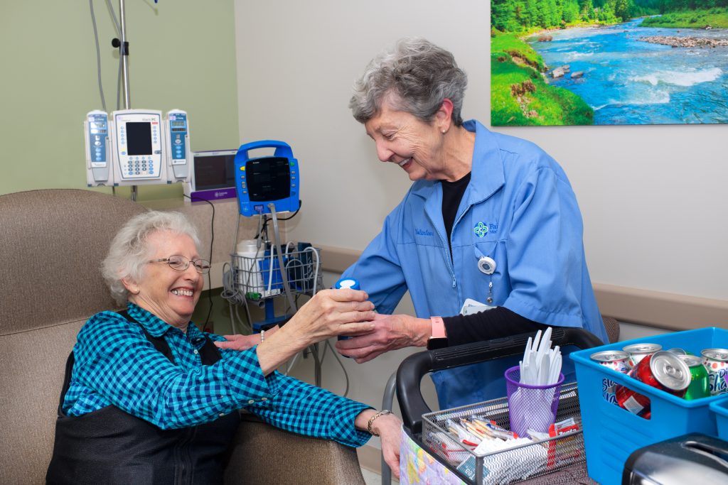 Volunteer helping cancer patient during treatment