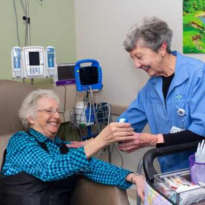 Volunteer helping cancer patient during treatment