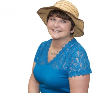Female cancer survivor with hat sitting