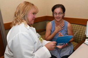 Patient receiving heartburn consultation from nurse