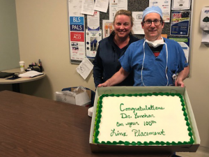 Dr. Yenchar and Tonya Mundy hold a celebratory cake