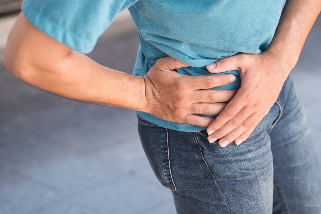 man holding hip in pain