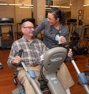Patient Bob Jones exercises in FMC's Cardiac Rehab Gym with nursing staff