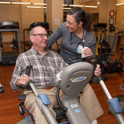 Patient Bob Jones exercises in FMC's Cardiac Rehab Gym with nursing staff
