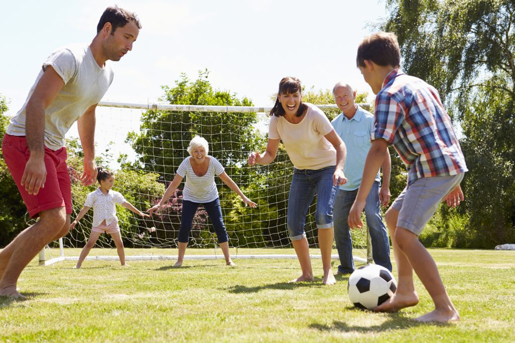 Multi generational family playing soccer