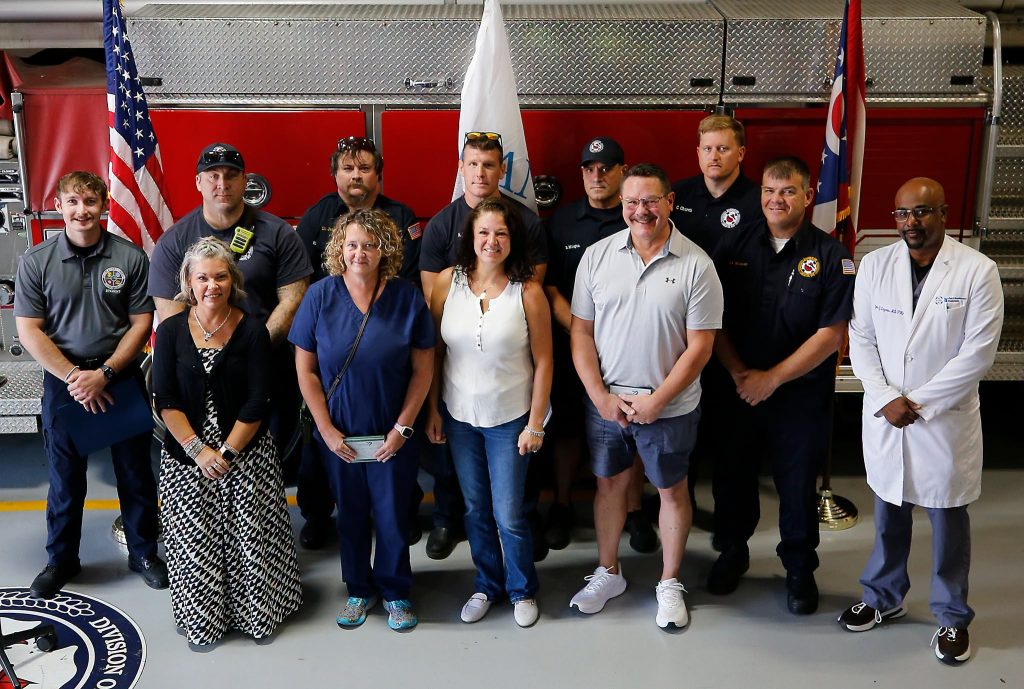 Cardiac arrest survivor Melanie Bowersock stands with rescuers at Great Save Award, photo by Lorrie Gardner, Columbus Division of Fire