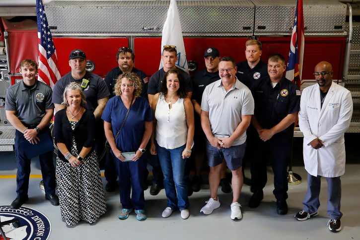 Cardiac arrest survivor Melanie Bowersock stands with rescuers at Great Save Award, photo by Lorrie Gardner, Columbus Division of Fire