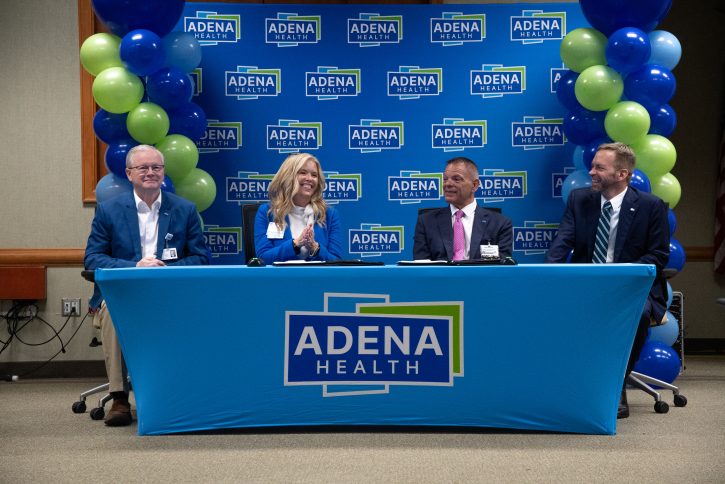 Adena Health and Fairfield Medical Center leadership sit at Adena-branded signing table