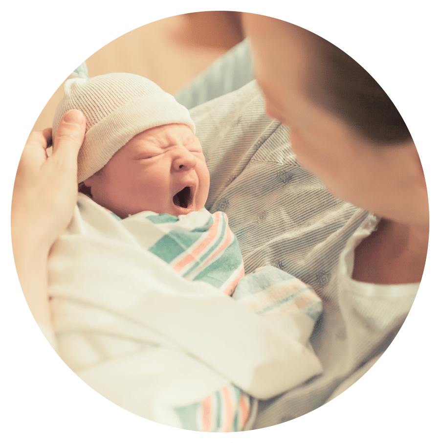 Cute sleepy baby. Mother holding her new born baby boy in her arms. 